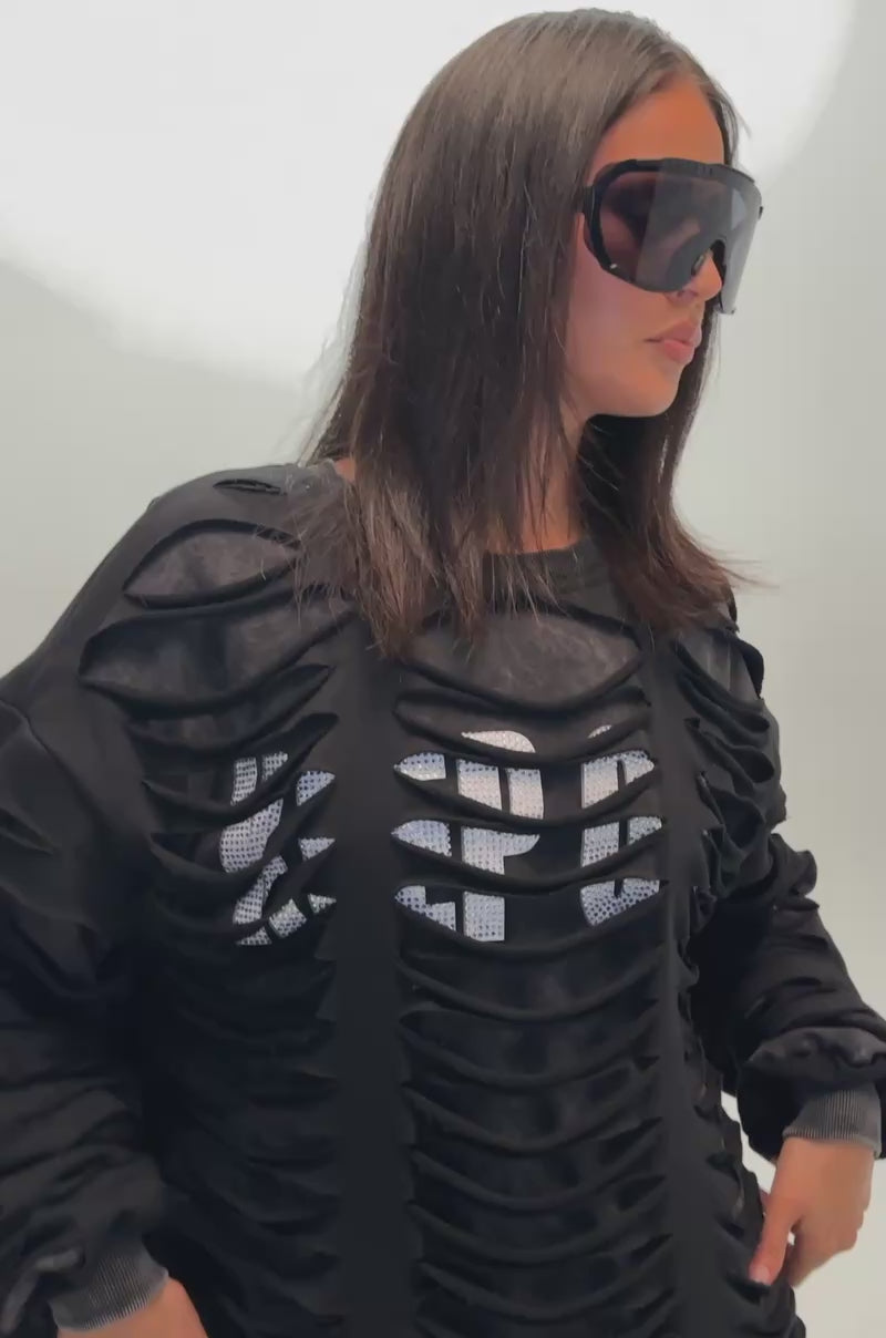 Video of a woman modeling the EASILY DISTRESSED SWEATSHIRT with slashed cutouts over mesh.