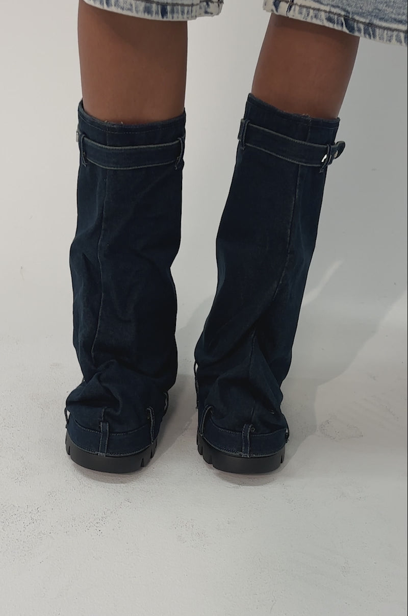 Video of woman modeling the AKIRA GOLD ANGELA FOLD OVER PLATFORM BOOT IN DARK DENIM with oversized light-wash denim shorts 