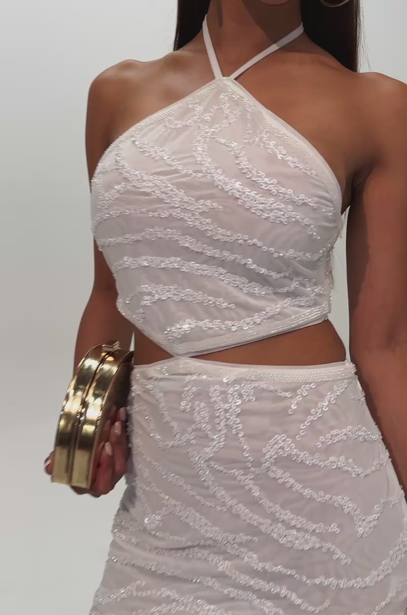A video of a woman wearing the PHOTO READY CUT OUT SEQUIN MINI DRESS.