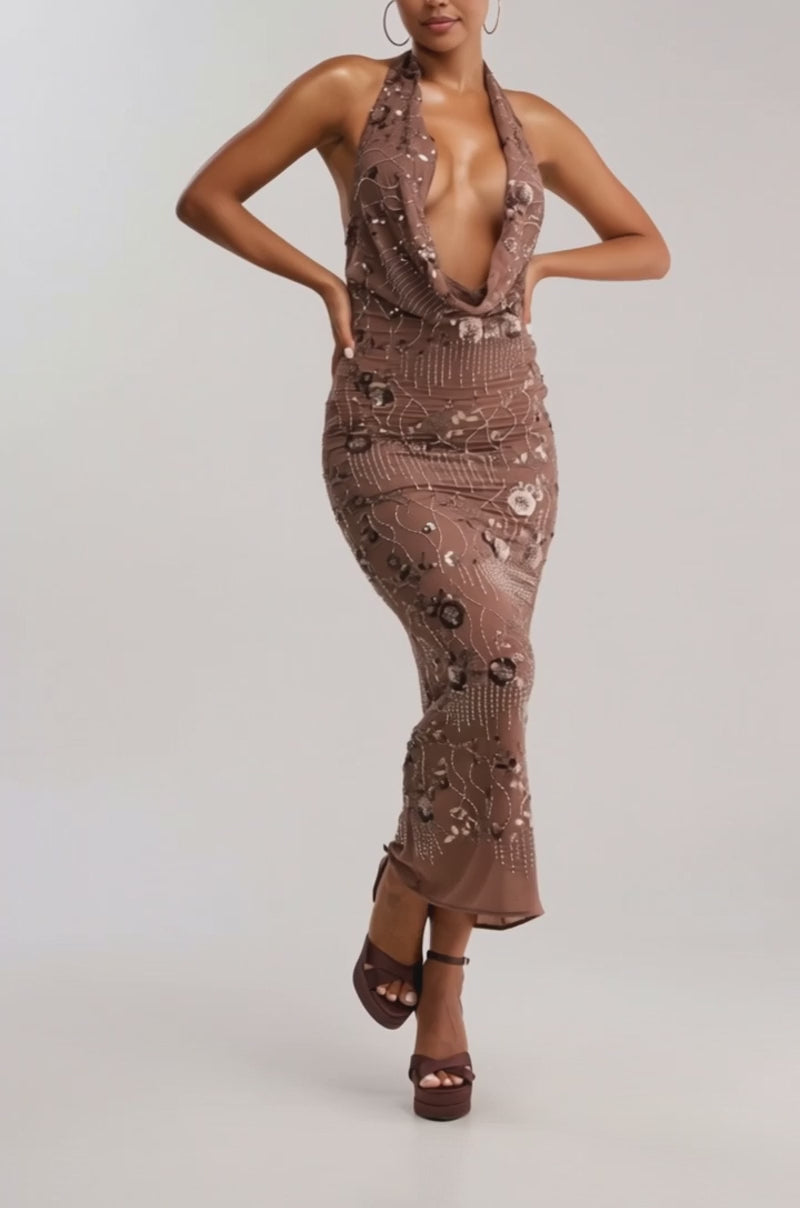 Video of woman modeling the LOVE LETTERS EMBELLISHED MAXI DRESS, a sleeveless, deep-plunge brown formal gown with sequin and bead details. 
