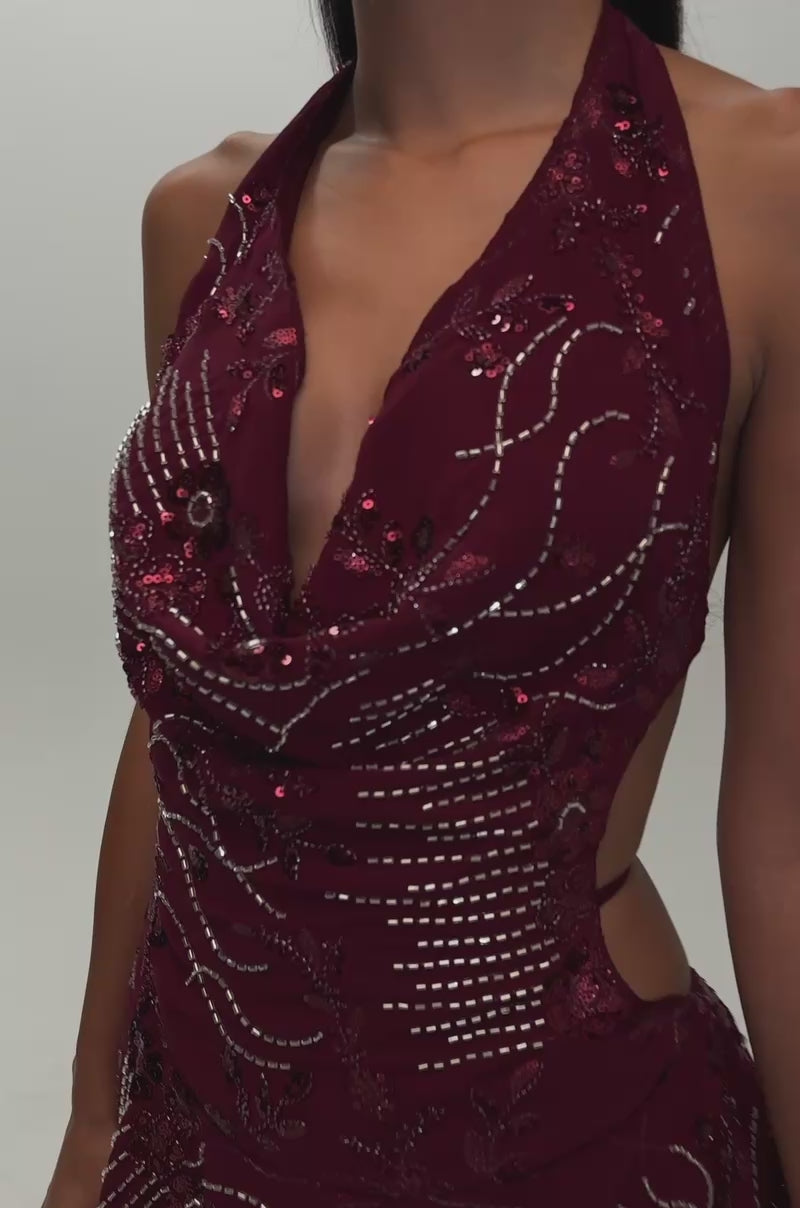 Video of a woman modeling the FELICITY EMBELLISHED MINI DRESS IN PLUM—a sleeveless, deep V-neck mini dress adorned with intricate bead and sequin detailing.