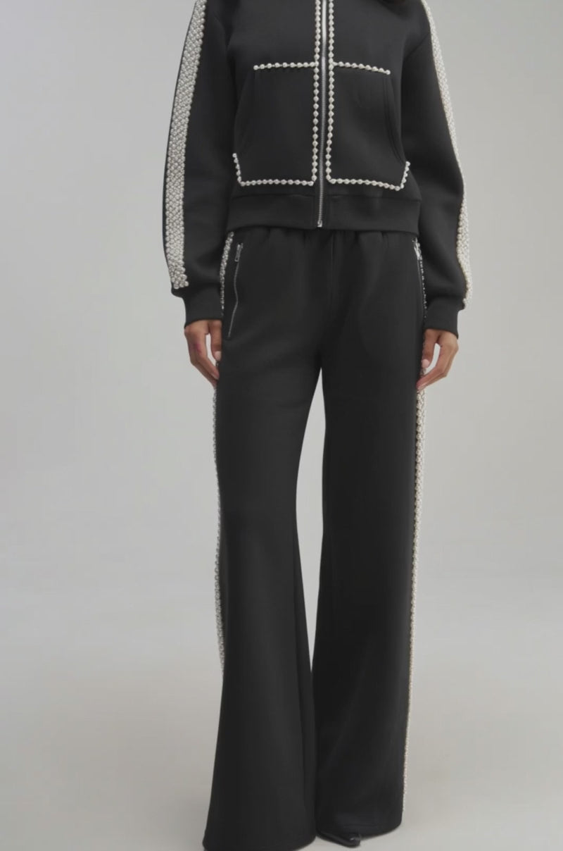 Video of a woman modeling the PEARL GIRL ZIP UP SWEATSHIRT and matching pearl-embellished pants.