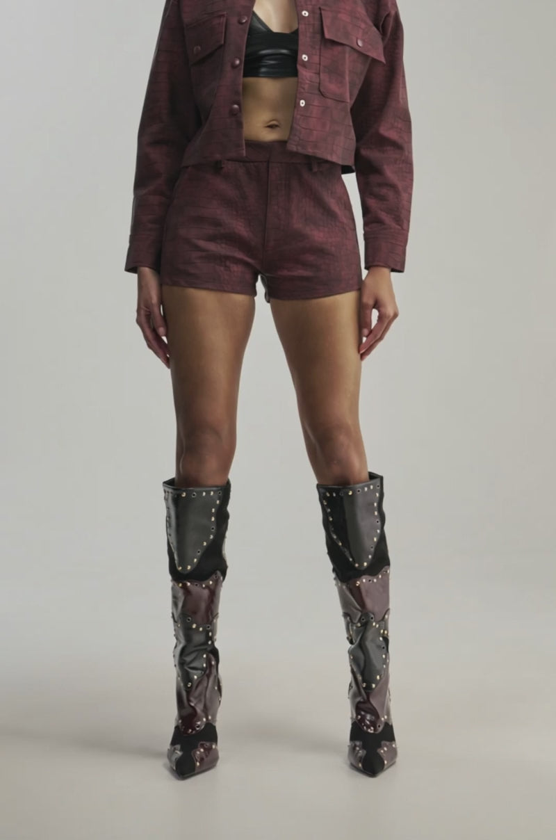 Video of a woman modeling the MOODY CROC SHORT—croc-embossed high-rise mini shorts.