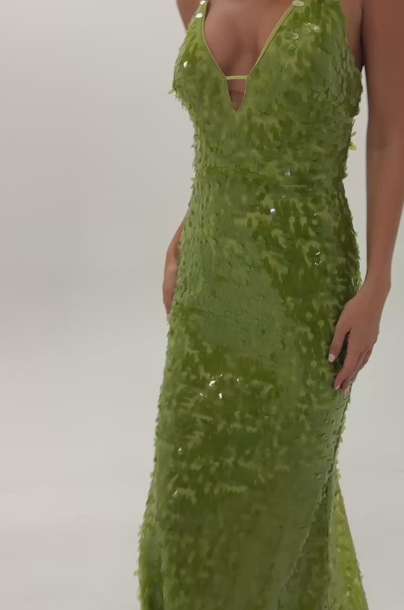 Video of woman modeling the WILD CARD SEQUIN MAXI DRESS IN LIME, a sleeveless, floor-length green sequin maxi dress with a deep V-neckline. This sparkling party dress is perfect for making a statement.