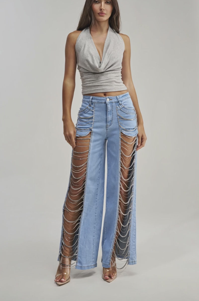 Video of a woman modeling the FIRST CLASS COWL HALTER TOP, a stretchy grey knit cowl neck halter.
