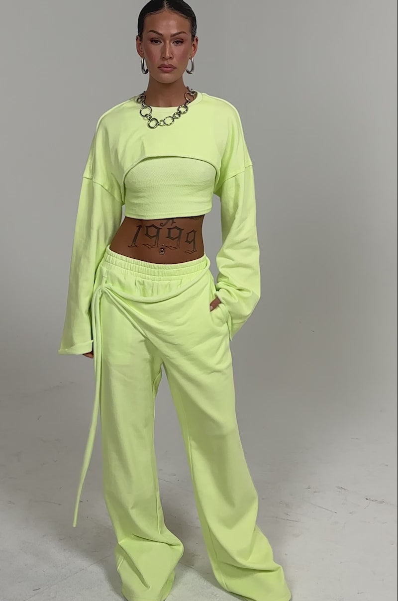 Video of woman modeling the TRY ME BABY CROP SWEATSHIRT and matching pants in lime