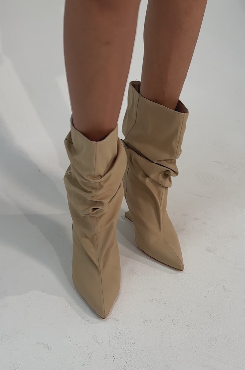 A video of a person wearing the AZALEA WANG SERONA KHAKI INVISIBLE WEDGE BOOTIE.