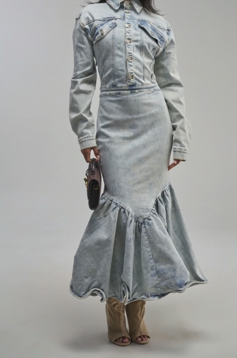Video of a woman modeling the DENIM FOR DAYS MAXI DRESS, a light-wash denim maxi with long sleeves and a ruffled hem. 