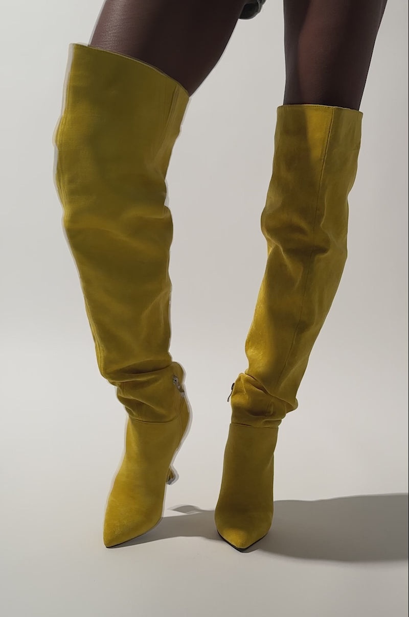 A video of a person wearing AZALEA WANG STEPHAN YELLOW FAUX SUEDE CHUNKY BOOTS and camouflage shorts.
