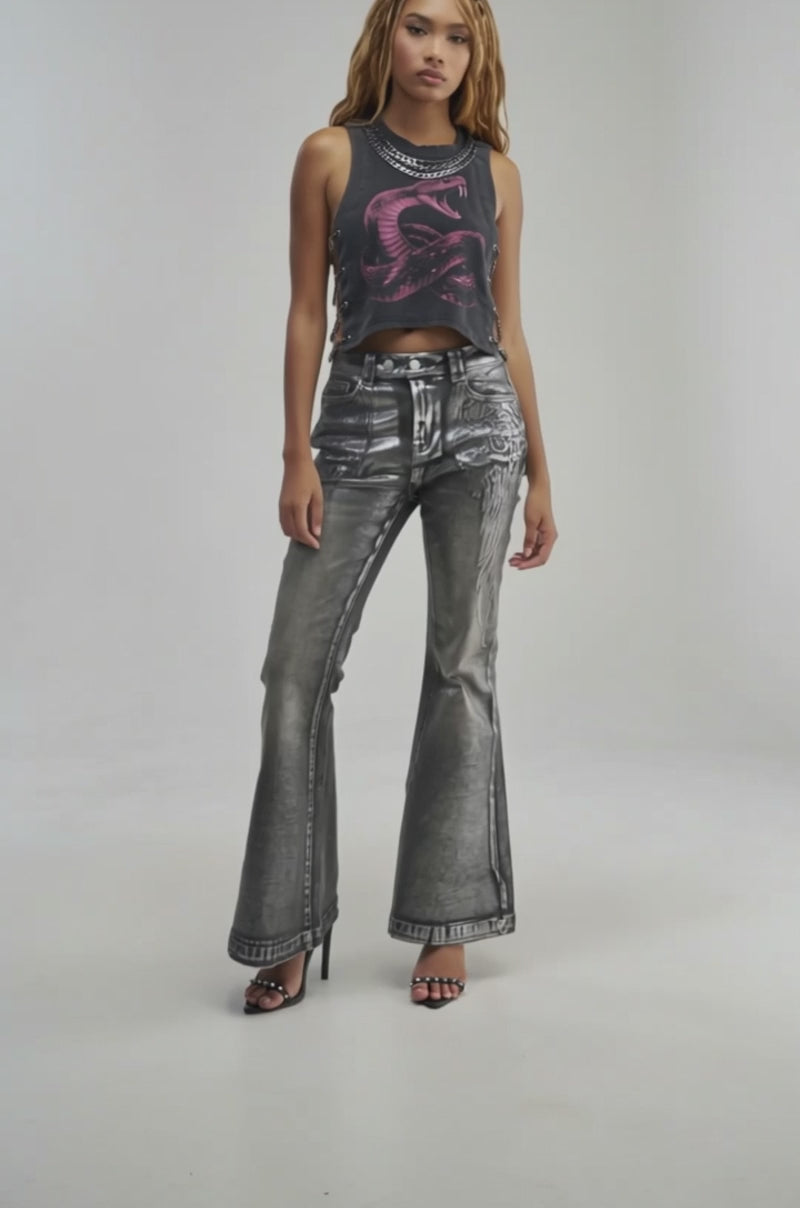 Video of a woman modeling the SNAKES IN THE GRASS CHAIN DETAIL TANK—a sleeveless black top featuring a striking red snake graphic and bold chain detailing.neutral background.