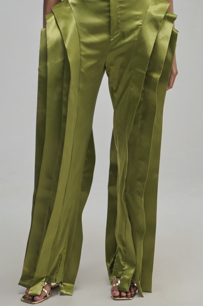 Video of a woman modeling the INFINITY TROUSER IN OLIVE—shiny satin trousers with a high-rise fit and layered panels.