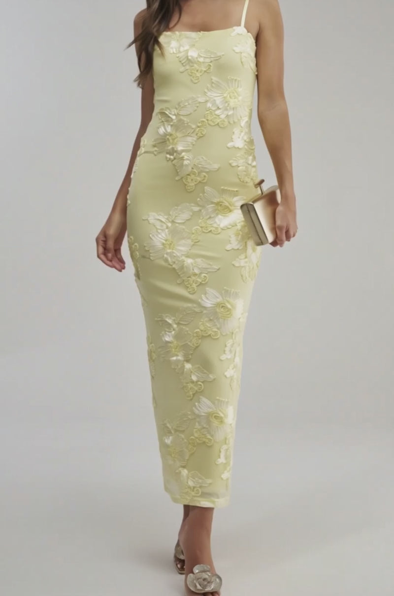A video of a woman in the TRY TO KEEP UP FLORAL MIDI DRESS IN YELLOW, a sleeveless midi dress with white floral print.
