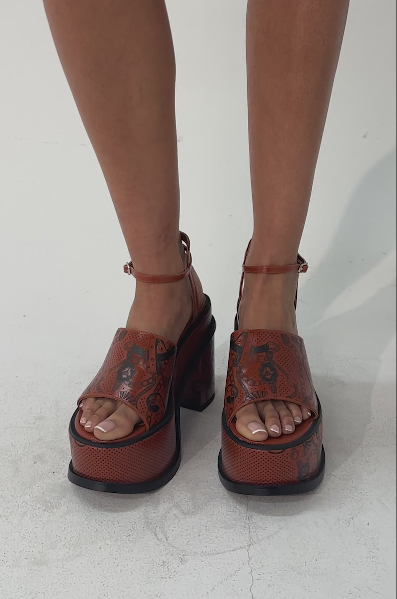 A video of a person wearing the AZALEA WANG ANTHELMINE COGNAC PLATFORM SANDAL WITH TATTOO DETAILING.