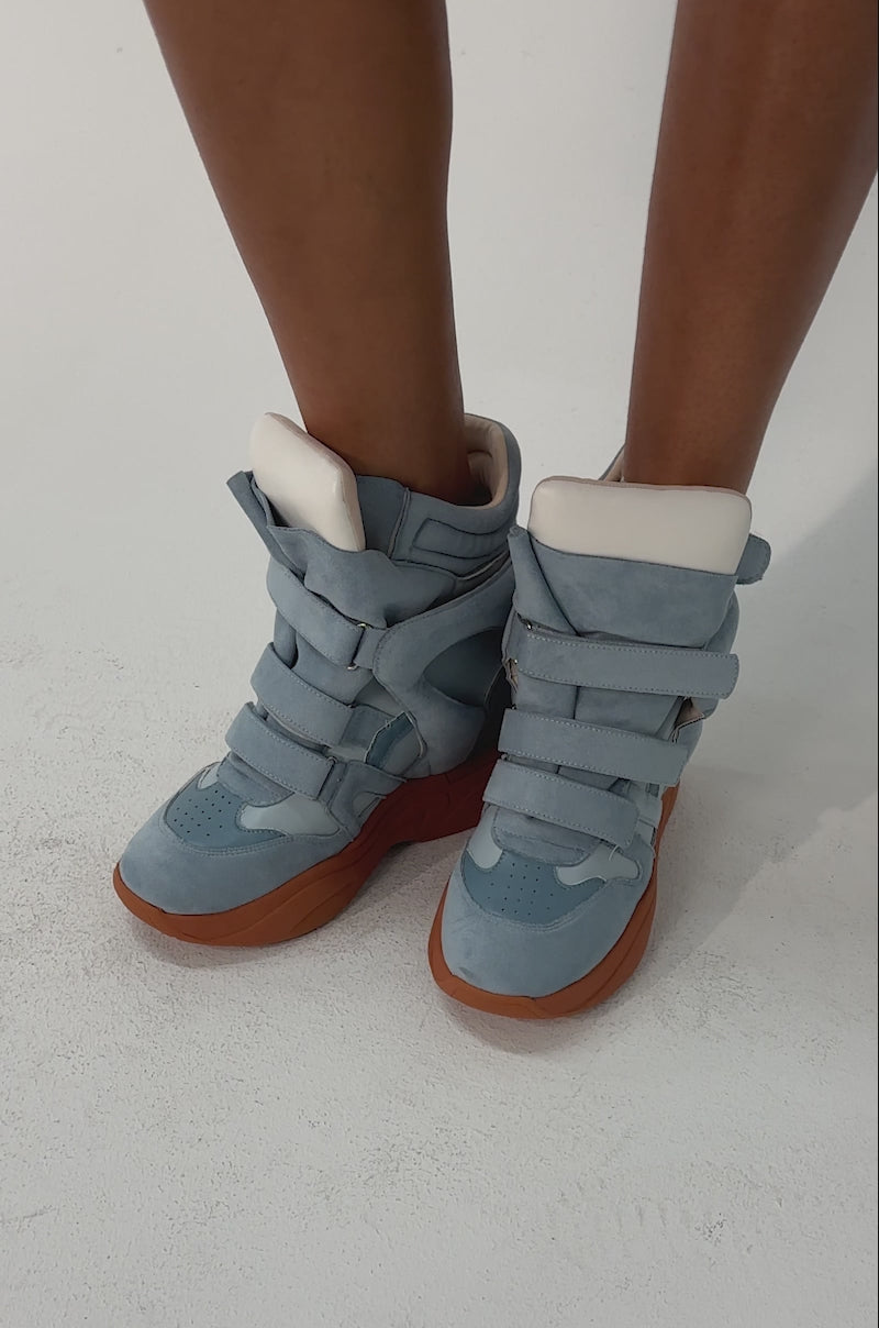 Video of woman modeling the MARANTO BLUE WEDGE FAUX SUEDE SNEAKERS. Only the lower half of the body is visible.