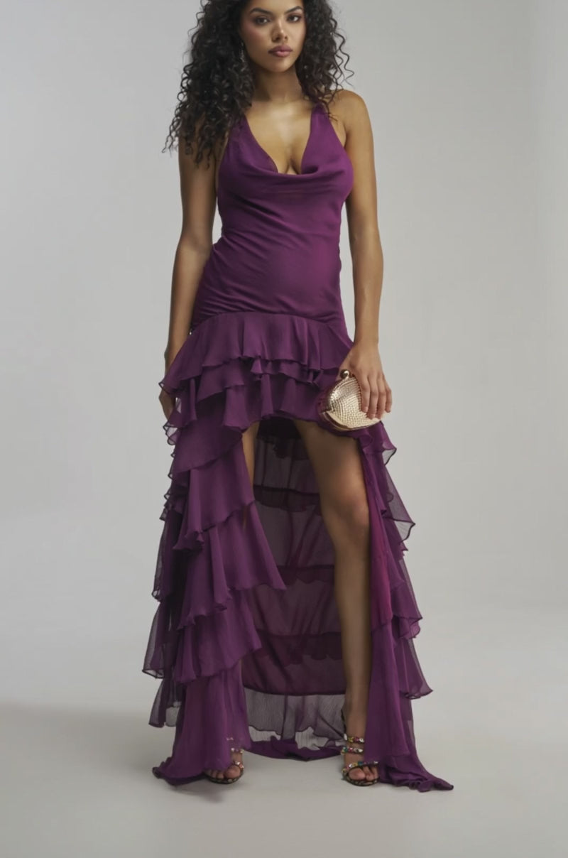 Video of woman modeling the TO ALL MY FANS CHIFFON RUFFLE MAXI DRESS in deep purple, holding a small gold clutch—an elegant choice for a wedding guest dress.