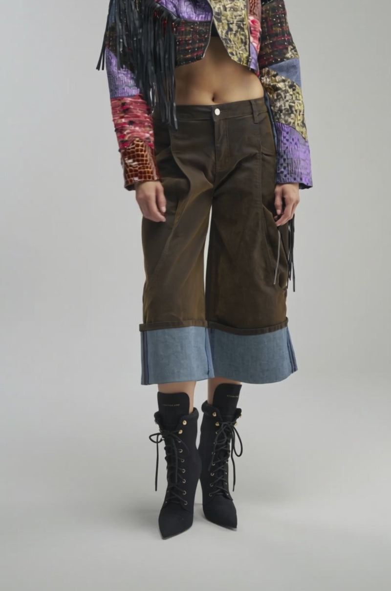 Video of a woman modeling the CAN’T STOP WON’T STOP PATCHWORK MOTO, its vibrant patchwork design and long black fringe accentuating the sleeves. 