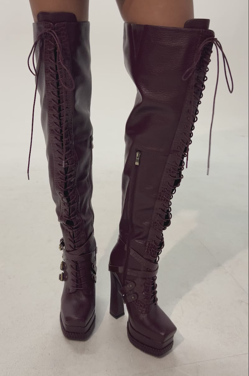 Video of woman modeling the AKIRA GOLD BLITZEN BURGUNDY THIGH HIGH PLATFORM CROC BOOT.
