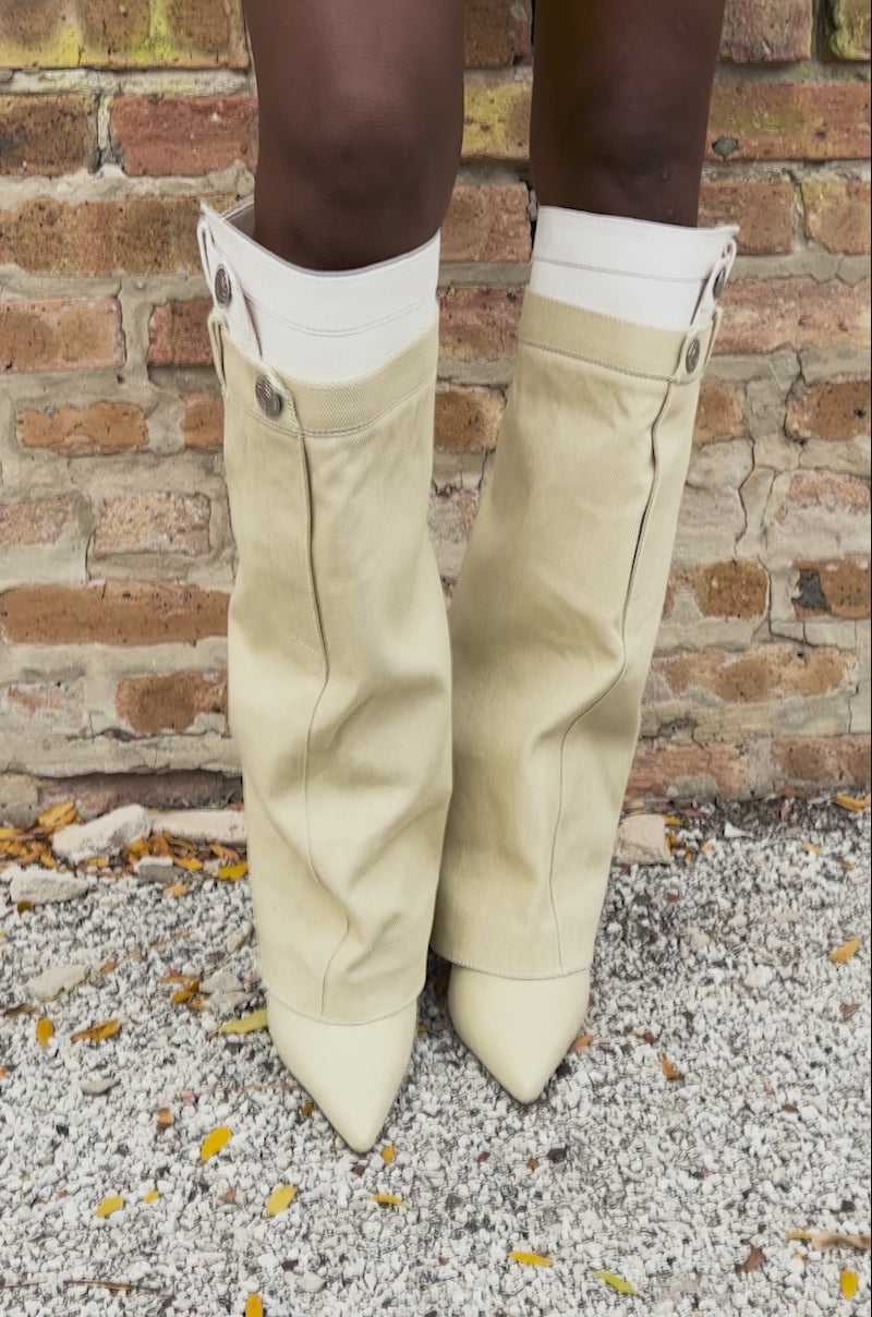 Video of woman modeling the AZALEA WANG DOUBLE FLY BEIGE CHUNKY BOOT—unique knee-high boots with belt loops, buttons, and pockets that mimic denim jeans.