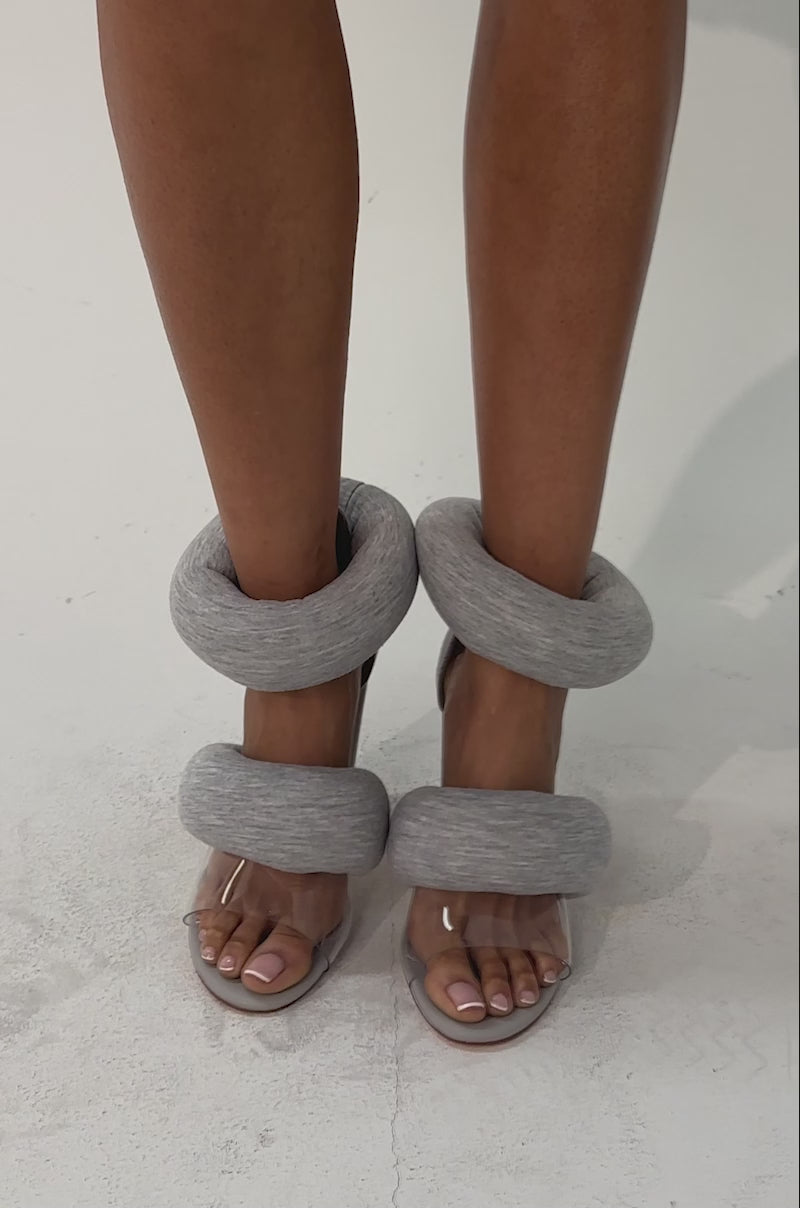A video of a model wearing the YANIX GREY PUFF SLIP ON SANDAL.