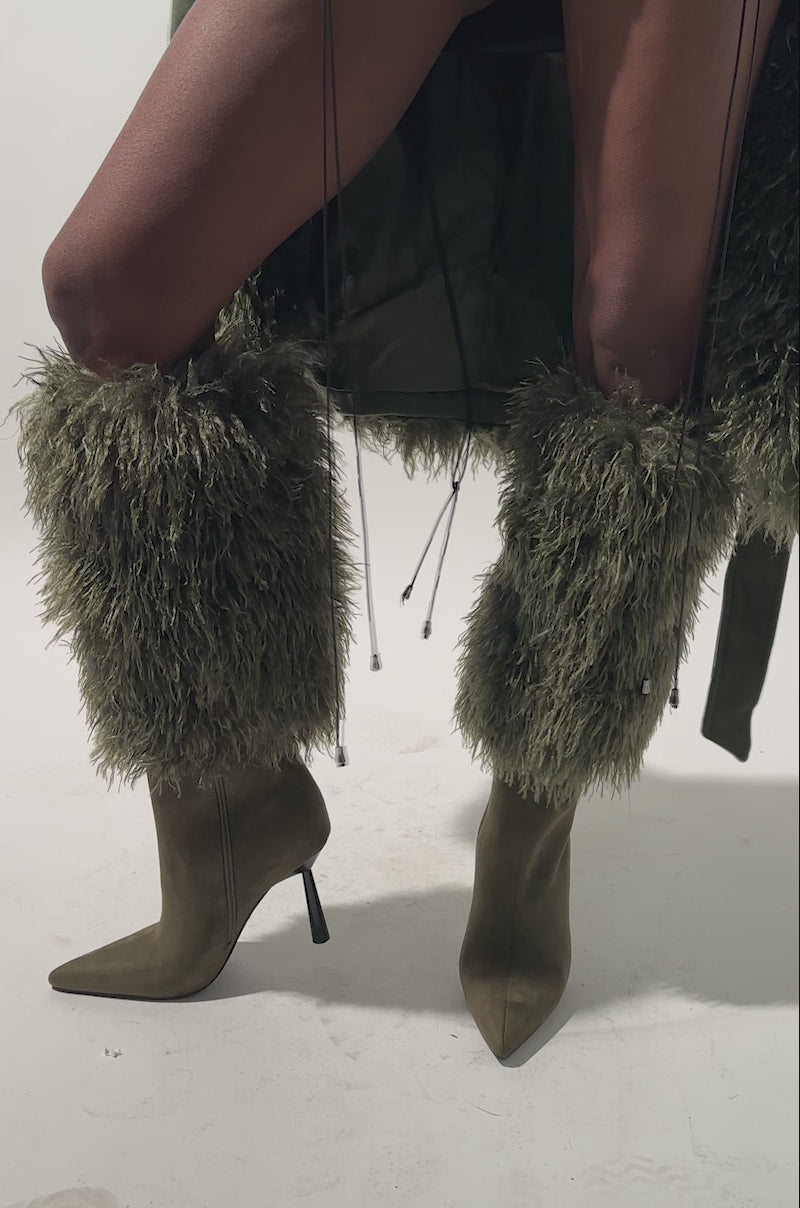 A video of a person wearing the AZALEA WANG VENDRISS OLIVE STILETTO FUR BOOTIEs. 