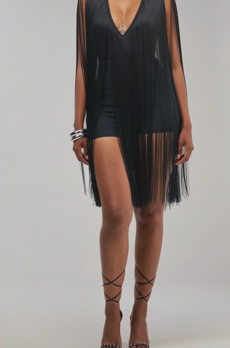 Video of a woman modeling the SHAKE IT FOR ME Sleeveless Bandage Romper with Fringe in Black.