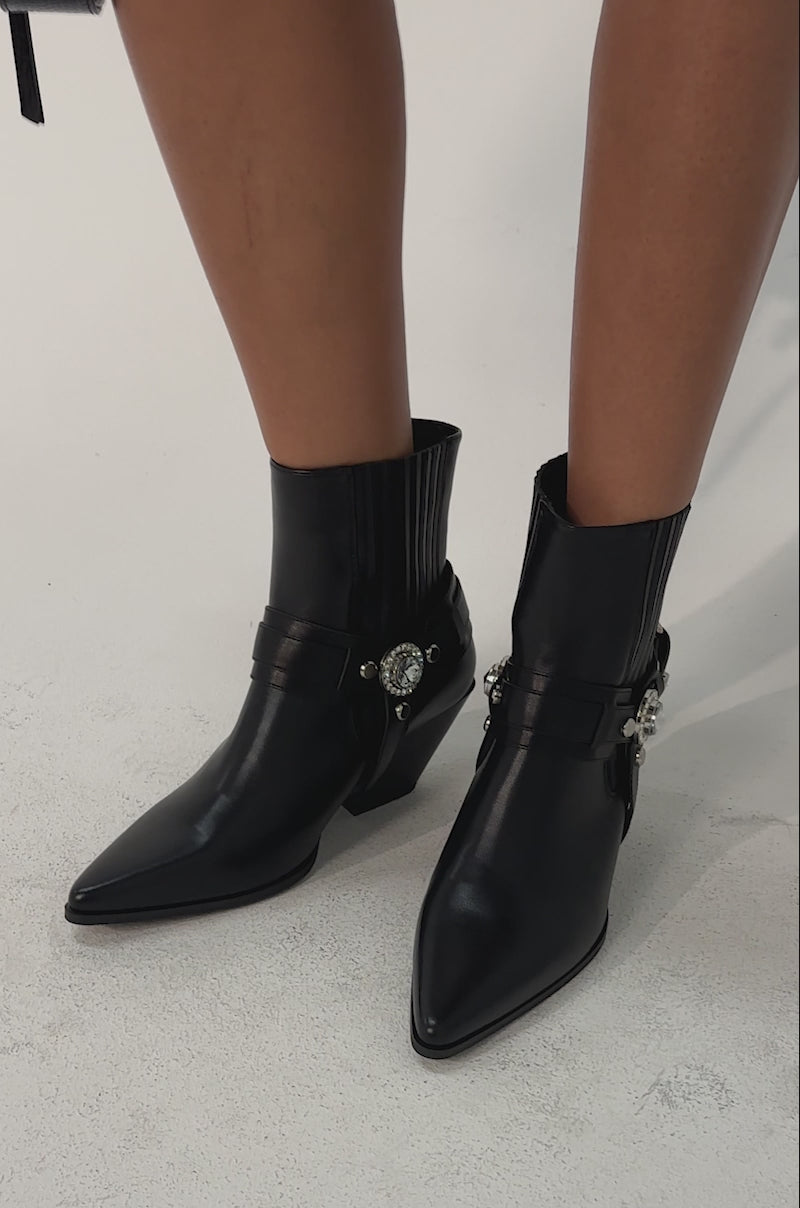 Video of woman modeling the AZALEA WANG LENKOV BLACK WESTERN BOOTS featuring decorative buckles. 