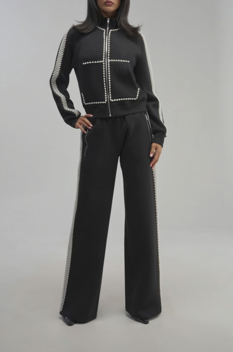 Video of a woman modeling the PEARL GIRL JOGGER—chic loungewear featuring a wide leg silhouette and white trim.