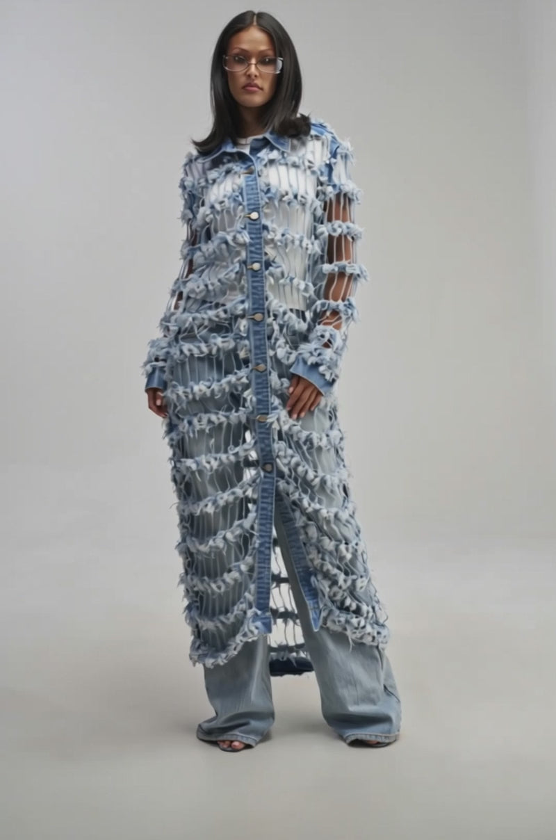 Video of a woman modeling the GOOD TIME NOT A LONG TIME DENIM TRENCH—a long, avant-garde distressed denim coat with large cutouts.