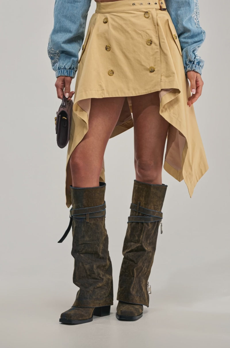 Video of a woman modeling the MAEVE MINI SKIRT in khaki with an asymmetrical hem.