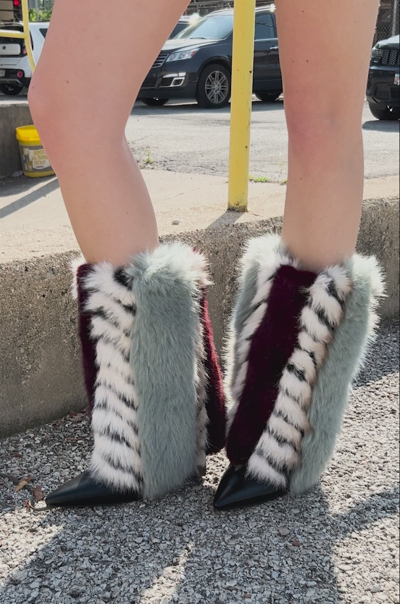 Video of person showing off the AZALEA WANG BRIASH BLUE MULTI FUR HIDDEN WEDGE BOOTIE featuring blue, burgundy, white, and black tiger-like stripes and a pointed toe.