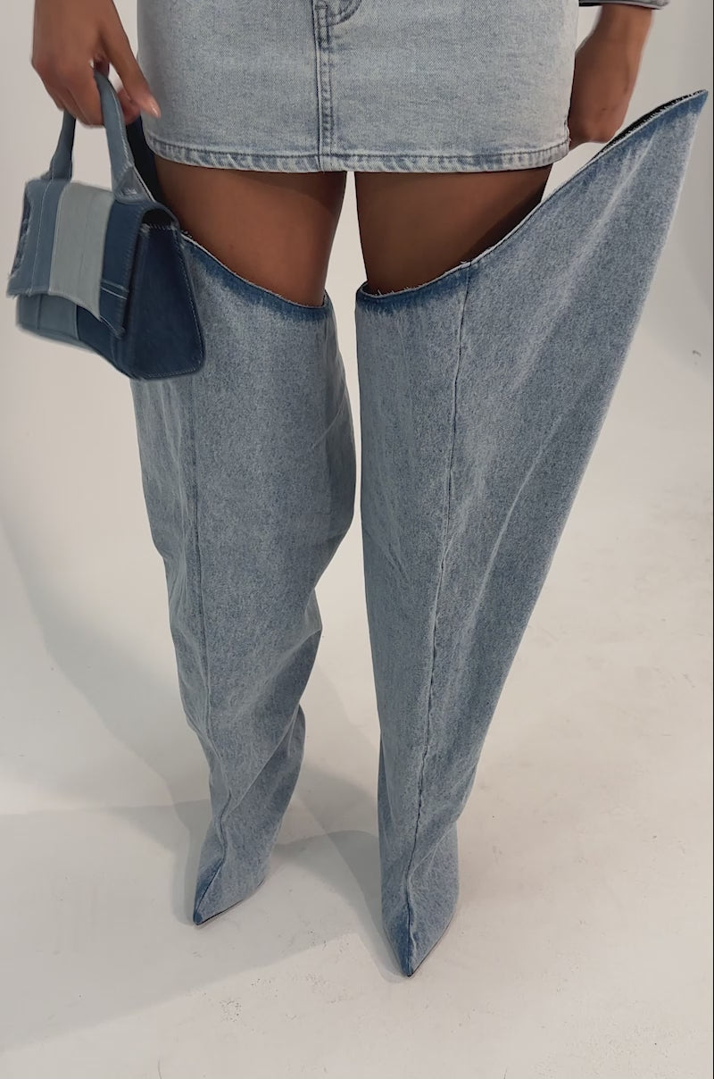 A video of a model wearing  the AKIRA GOLD JANELISSE DENIM STILETTO BOOT.
