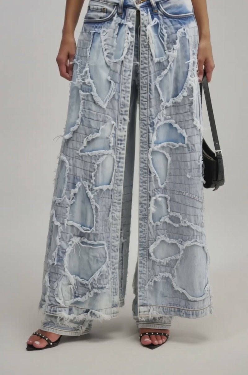 A video of a model wearing the CRAZY FOR YOU SUPER DISTRESSED DENIM, styled with black high-heeled sandals.