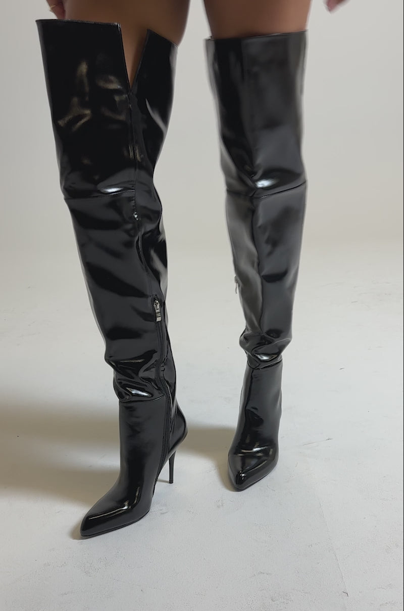 A video of a person wearing AZALEA WANG SUNSHINE THIGH HIGH BLACK PU STILETTO BOOTS, with only the lower legs and the shiny, over-the-knee boots visible.