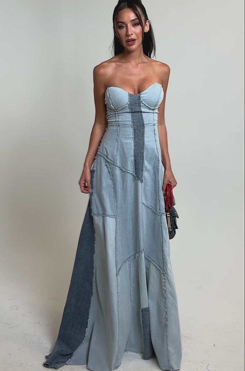 A video of a woman wearing the IT'S BRITNEY PATCHWORK DENIM MAXI DRESS, featuring strapless light and dark blue denim panels. 