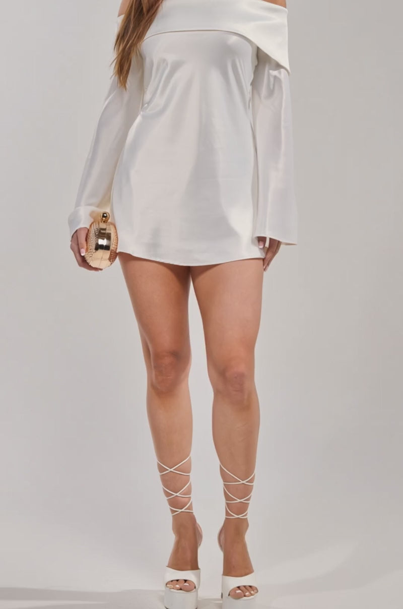 A video of a woman wearing the CLASSY YET SASSY LONG SLEEVE SATIN MINI DRESS, styled for bridal events. 
