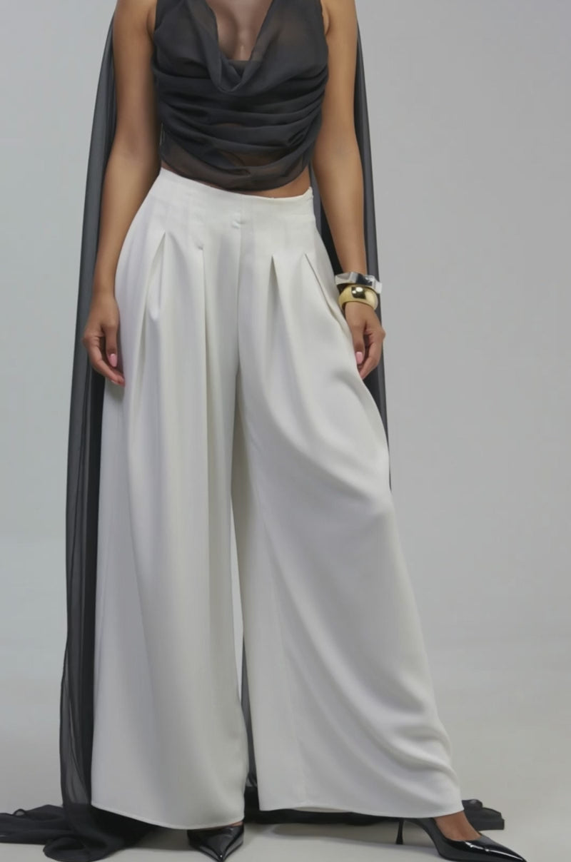 Video of a woman modeling the ANGELIC CHIFFON BLOUSE—a sheer black, draped top with flowing fabric.
