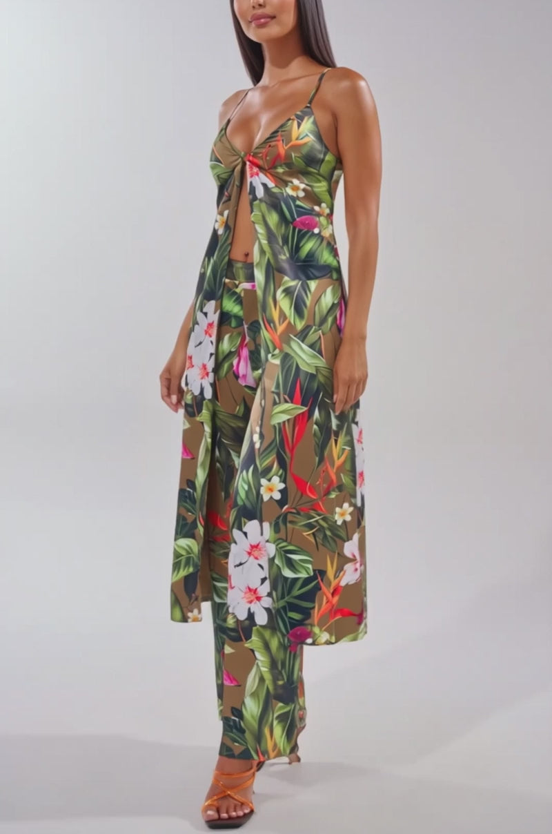 Video of woman modeling the INTO THE WILD FLORAL BLOUSE, a sleeveless tie-front top styled with matching wide-leg pants and strappy sandals.