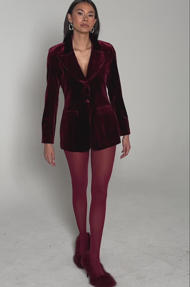 Video of woman modeling the LUXE VELVET TUXEDO BLAZER, a red single-button piece paired with matching shorts