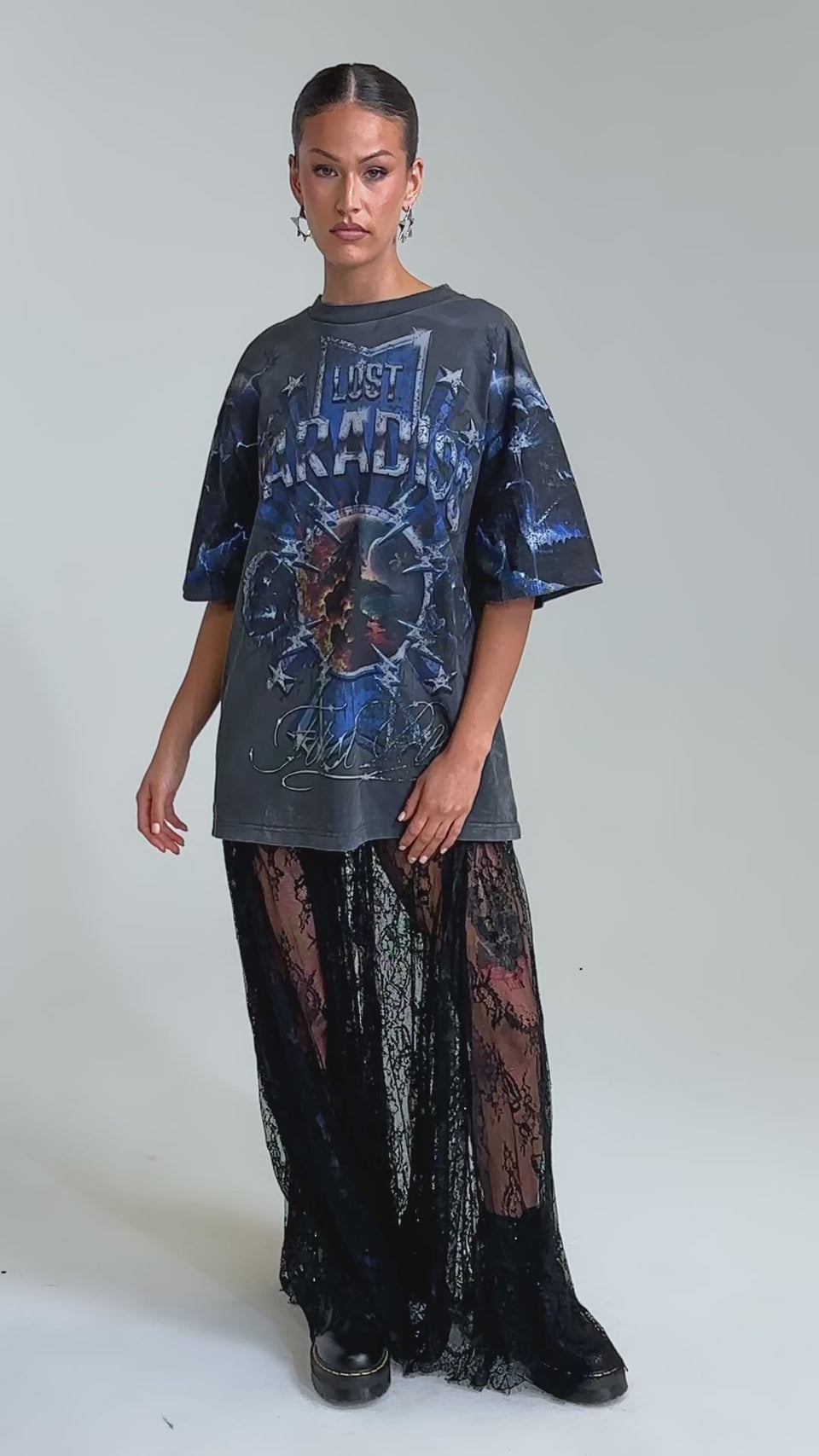 Video of woman modeling the LOVELY DAYS LACE MAXI SKIRT and black platform shoes, standing against a plain light background—a bold twist on contemporary resort wear.