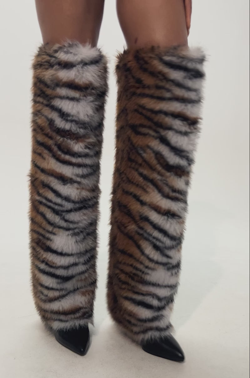 Video of woman modeling the AZALEA WANG PURR TIGER FUR THIGH HIGH BOOTS—bold tiger print with faux fur over black pointed-toe shoes. Only the legs and part of the outfit are visible.