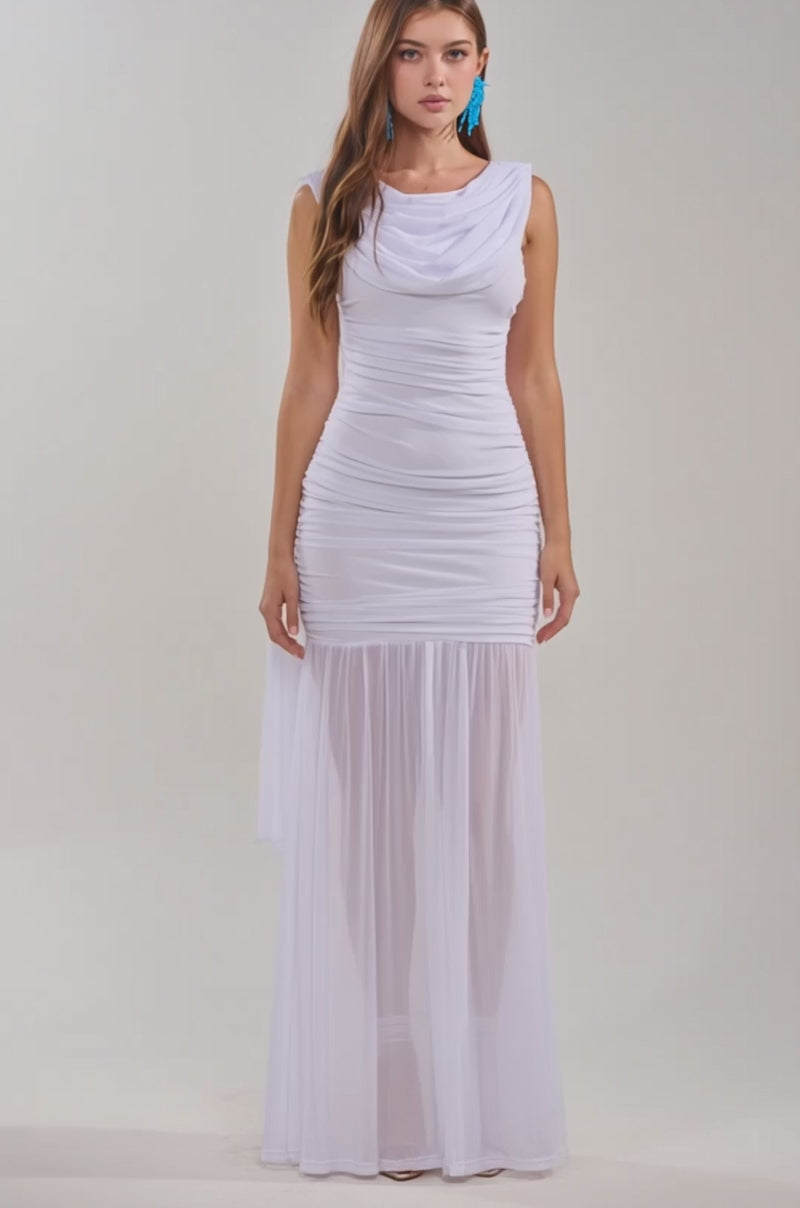 A video of a woman wearing the TRENDSETTER ENERGY Layered Maxi Dress in white, featuring sheer mesh from the knees down and gathered bodice detailing.