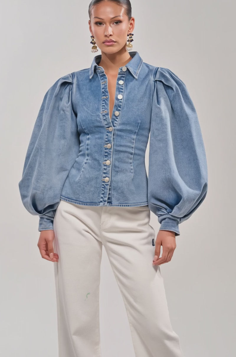 Video of woman modeling the JULIANA DENIM BLOUSE with voluminous puffed sleeves and white pants.
