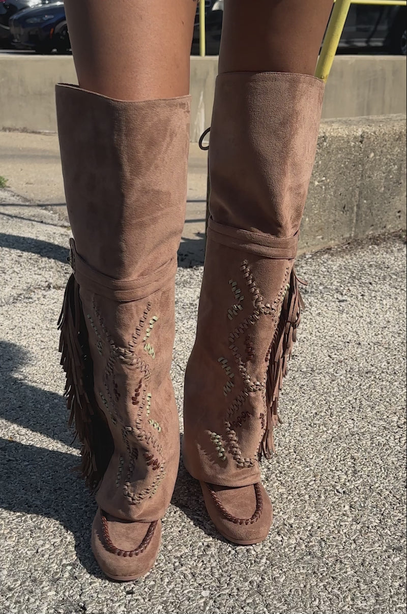 Video of woman modeling the AZALEA WANG EDMUND BROWN FLAT WESTERN BOOTS featuring fringe accents and embroidered leaf designs in faux suede.