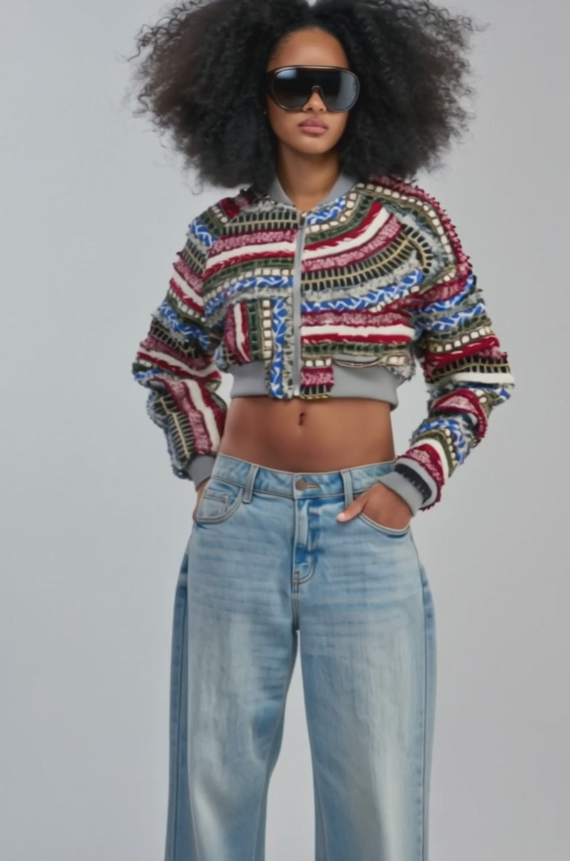 Video of a woman modeling the FAYE TEXTURED BOMBER—a colorful textured streetwear jacket.