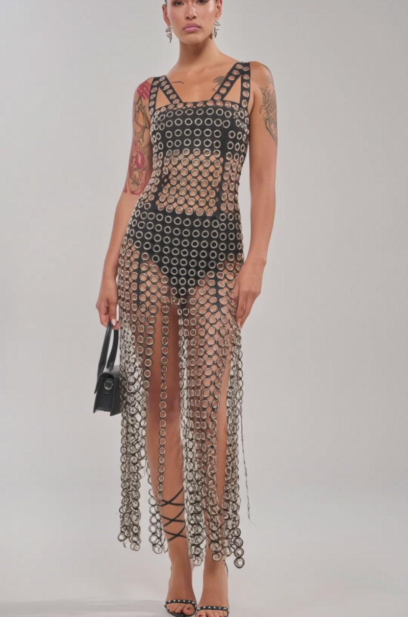 Video of woman modeling the FLIRT ALERT CHAIN MIDI DRESS, a sleeveless see-through fringe dress.