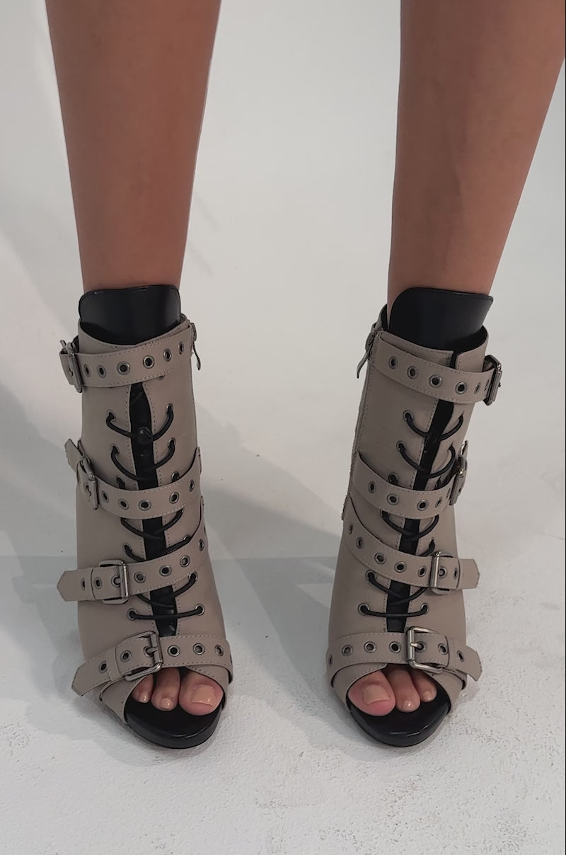 A video of a person wearing the AZALEA WANG LOOM TAUPE OPEN TOE BOOTIE.
