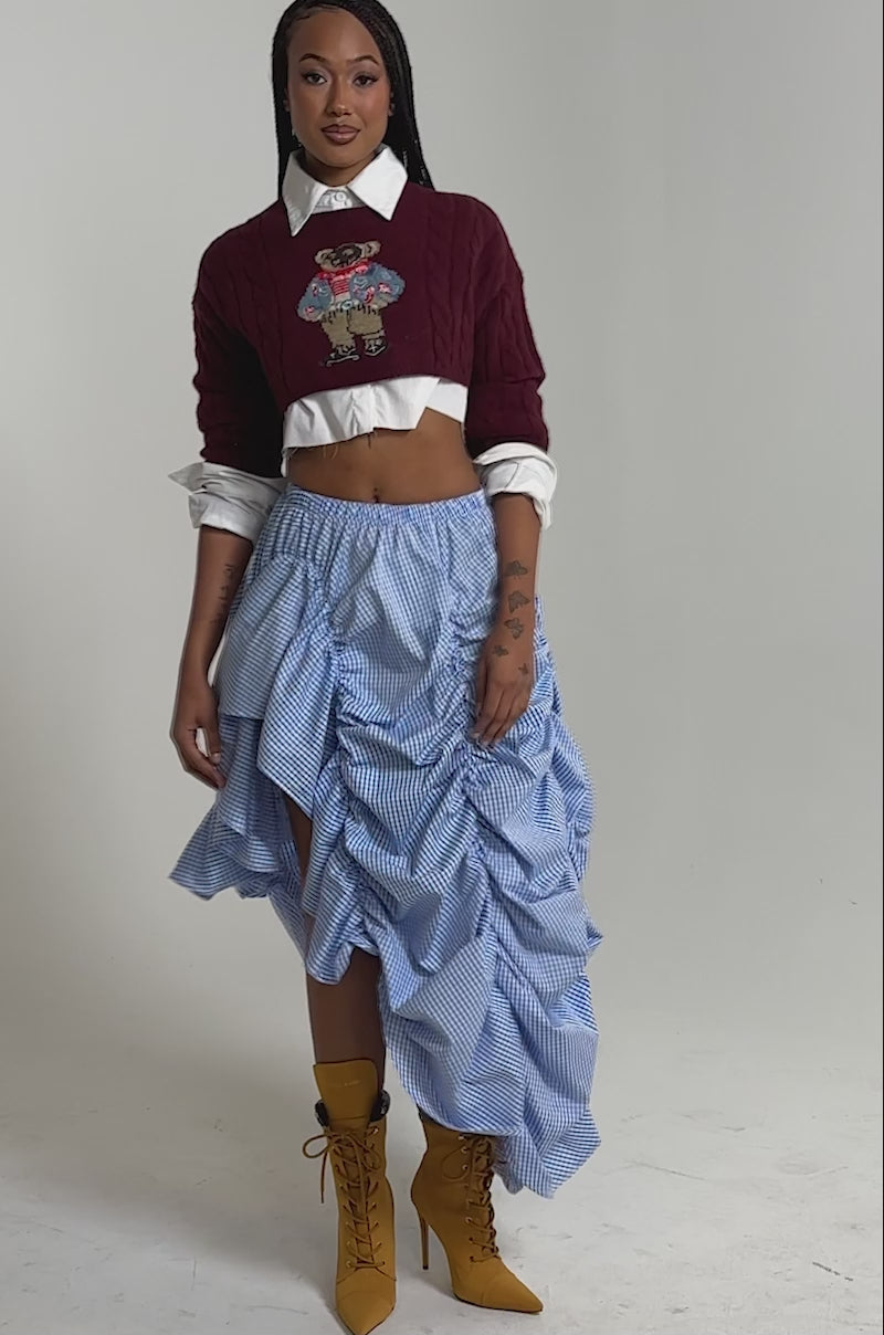 A video of a person wearing the COASTING STRIPE RUCHED SKIRT and mustard-yellow heeled boots.
