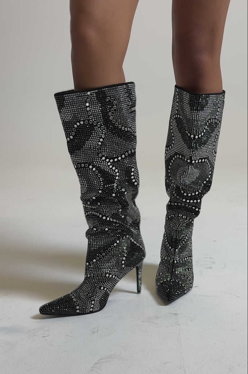 A video of a person wearing the AZALEA WANG ISILDA BLACK MULTI SEQUIN STILETTO BOOTS standing against a plain gray background.