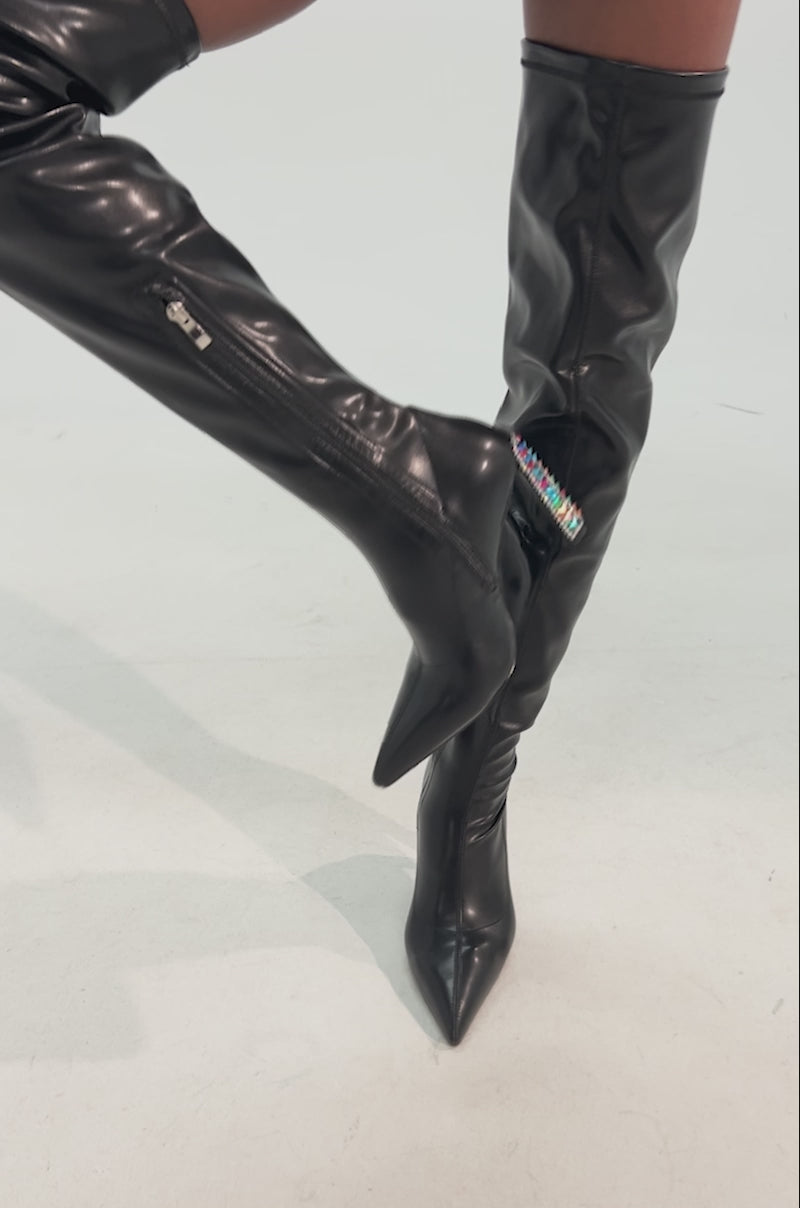 Video of woman modeling the AZALEA WANG COSMIC BLING BLACK BOOT. Its tall block heel is embellished with colorful rhinestones
