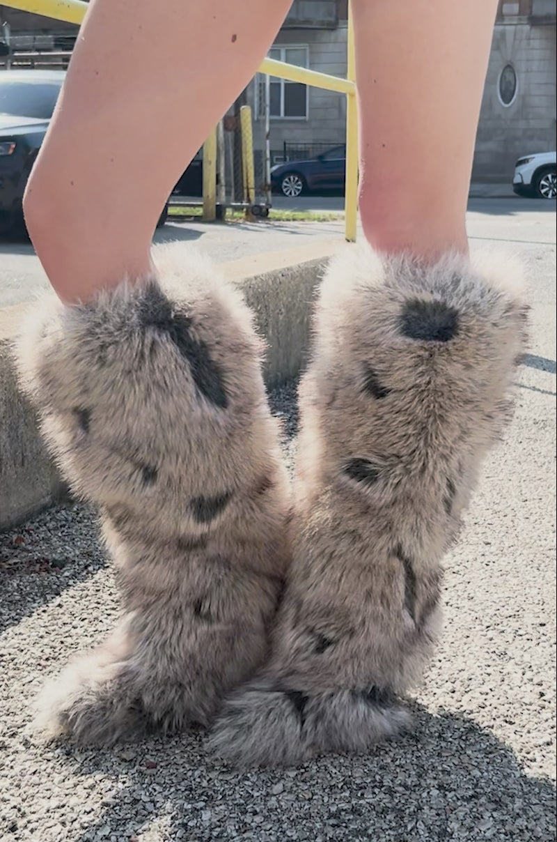 Video of person modeling the AZALEA WANG DEBBY GREY MULTI FUR STILETTO BOOTIE. The boot features a knee-high length, pointed toe boot covered in fluffy grey faux fur with black spots for a bold and unique look.